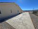 Side view of the house with a long driveway and partial fencing in the background at 2080 Mount Charleston Dr, Pahrump, NV 89048