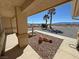 Home's front porch area with water fountain feature, desert landscaping, palm trees, and mountain views at 2080 Mount Charleston Dr, Pahrump, NV 89048