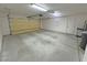 Interior view of an empty two-car garage with a side entrance door and overhead lights at 2080 Mount Charleston Dr, Pahrump, NV 89048