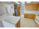 Spacious kitchen featuring a stainless steel refrigerator, oak cabinets, and a tile countertop at 2080 Mount Charleston Dr, Pahrump, NV 89048