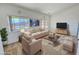 Staged living room showcases large windows, comfortable seating, and modern decor for stylish living at 2080 Mount Charleston Dr, Pahrump, NV 89048