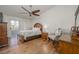 Bedroom with wood floors, ceiling fan, dresser, and sliding glass door to patio at 2194 Camel Mesa Dr, Laughlin, NV 89029