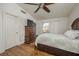 Bedroom with wood floors, ceiling fan, dresser, and a large bed at 2194 Camel Mesa Dr, Laughlin, NV 89029