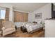 Cozy bedroom with hardwood floors, a decorative bed, a wingback chair and natural light at 2194 Camel Mesa Dr, Laughlin, NV 89029