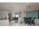 Bright dining area with tile flooring, multiple tables, ceiling fans, and patterned window treatments at 2194 Camel Mesa Dr, Laughlin, NV 89029