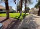 The exterior of the property features a well-maintained lawn with trees providing shade at 2194 Camel Mesa Dr, Laughlin, NV 89029