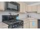 Well-lit kitchen featuring black appliances, light countertops, ample wooden cabinetry, and modern fixtures at 2194 Camel Mesa Dr, Laughlin, NV 89029