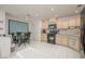 Well-lit kitchen with light wood cabinets, black appliances, and an adjacent dining area at 2194 Camel Mesa Dr, Laughlin, NV 89029