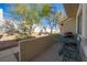 Relaxing patio area featuring a grill and table set, surrounded by desert landscaping and a secure fence at 2194 Camel Mesa Dr, Laughlin, NV 89029