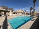 The community pool is surrounded by palm trees, and has a covered dining area at 2194 Camel Mesa Dr, Laughlin, NV 89029