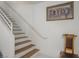 Staircase with wooden steps, a white handrail, and decoratively painted wall at 2194 Camel Mesa Dr, Laughlin, NV 89029