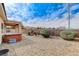 Private backyard with gravel landscaping, covered patio, and relaxing hot tub, perfect for outdoor living at 2204 Bay Thrush Way, North Las Vegas, NV 89084