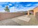 Gravel backyard featuring a patio, wall, and covered area, offering a tranquil outdoor space at 2204 Bay Thrush Way, North Las Vegas, NV 89084