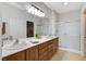 Bathroom featuring double sinks, granite countertops, and a walk-in shower at 2204 Bay Thrush Way, North Las Vegas, NV 89084