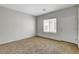 Bright bedroom with carpet, a window, and white door at 2204 Bay Thrush Way, North Las Vegas, NV 89084