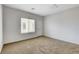 Carpeted bedroom with a white door and window at 2204 Bay Thrush Way, North Las Vegas, NV 89084