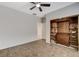 Bedroom showcasing tile flooring, a ceiling fan, and a built-in cabinet at 2204 Bay Thrush Way, North Las Vegas, NV 89084