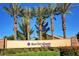 Beautifully landscaped community entrance sign with lush greenery and clear skies at 2204 Bay Thrush Way, North Las Vegas, NV 89084