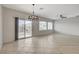 Spacious dining room featuring tile flooring, ample natural light, and contemporary chandelier at 2204 Bay Thrush Way, North Las Vegas, NV 89084