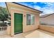 Charming home entrance with a vibrant green door and cozy porch at 2204 Bay Thrush Way, North Las Vegas, NV 89084