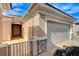 Close-up view of the house's front entrance, showing the front door, garage, and brick accents at 2204 Bay Thrush Way, North Las Vegas, NV 89084