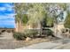 Single story home with a well-maintained front yard with mature tree and desert landscaping at 2204 Bay Thrush Way, North Las Vegas, NV 89084