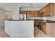 Open kitchen featuring stainless steel appliances, tile flooring, and a kitchen island with counter seating at 2204 Bay Thrush Way, North Las Vegas, NV 89084