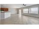 Bright living room features tile flooring, large windows, and a kitchen with a breakfast bar at 2204 Bay Thrush Way, North Las Vegas, NV 89084