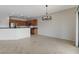 Open living area with tile flooring and modern lighting, seamlessly connecting the kitchen and dining spaces at 2204 Bay Thrush Way, North Las Vegas, NV 89084