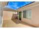 A side patio with a green door, window, and painted concrete, adjacent to the main house at 2204 Bay Thrush Way, North Las Vegas, NV 89084