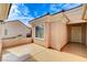 Enclosed patio with a light-colored concrete floor and tan walls, showing the front door at 2204 Bay Thrush Way, North Las Vegas, NV 89084