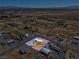 Aerial view showcasing a single-story house, set in a vast desert landscape at 240 Ember St, Pahrump, NV 89048