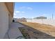 Backyard featuring a block wall, grass, and concrete patio at 240 Ember St, Pahrump, NV 89048