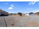 Spacious gravel backyard featuring a detached garage, desert landscaping, and a clear blue sky at 240 Ember St, Pahrump, NV 89048