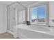 Bathroom boasting a soaking tub, a glass-enclosed shower, and a bright window at 240 Ember St, Pahrump, NV 89048