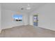 Neutral bedroom featuring plush carpet, vaulted ceilings, and access to the back patio at 240 Ember St, Pahrump, NV 89048