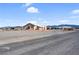 Charming single-story home featuring a large, gravel-covered yard with mountain views and a long driveway at 240 Ember St, Pahrump, NV 89048