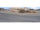 Desert home features an extended driveway and low-maintenance landscaping at 240 Ember St, Pahrump, NV 89048