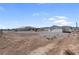 Spacious lot featuring a detached garage and home under a blue sky at 240 Ember St, Pahrump, NV 89048