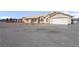 Inviting single-story home featuring a two-car garage and low maintenance gravel landscaping at 240 Ember St, Pahrump, NV 89048