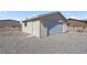 Exterior of detached one-car garage featuring overhead door at 240 Ember St, Pahrump, NV 89048