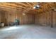 The garage interior is unfinished, showing exposed wood framing at 240 Ember St, Pahrump, NV 89048