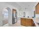 Kitchen with stainless steel refrigerator, wooden cabinets, and tiled floors at 240 Ember St, Pahrump, NV 89048