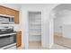 Pantry within kitchen featuring wooden cabinets, microwave, oven, and tile flooring at 240 Ember St, Pahrump, NV 89048