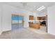 Bright kitchen with sliding door access, wooden cabinets, and stainless steel appliances at 240 Ember St, Pahrump, NV 89048