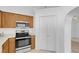 Kitchen featuring wooden cabinetry, microwave, oven, and tile flooring at 240 Ember St, Pahrump, NV 89048