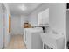 Well-lit laundry room featuring modern appliances, tiled floors, and ample storage space at 240 Ember St, Pahrump, NV 89048