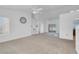 Open-concept living room featuring large windows, a ceiling fan, and built-in shelves at 240 Ember St, Pahrump, NV 89048