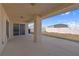 A covered patio features a concrete floor and sliding glass doors leading to the interior at 240 Ember St, Pahrump, NV 89048