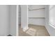 Spacious walk-in closet with ample storage and natural light from the window at 240 Ember St, Pahrump, NV 89048